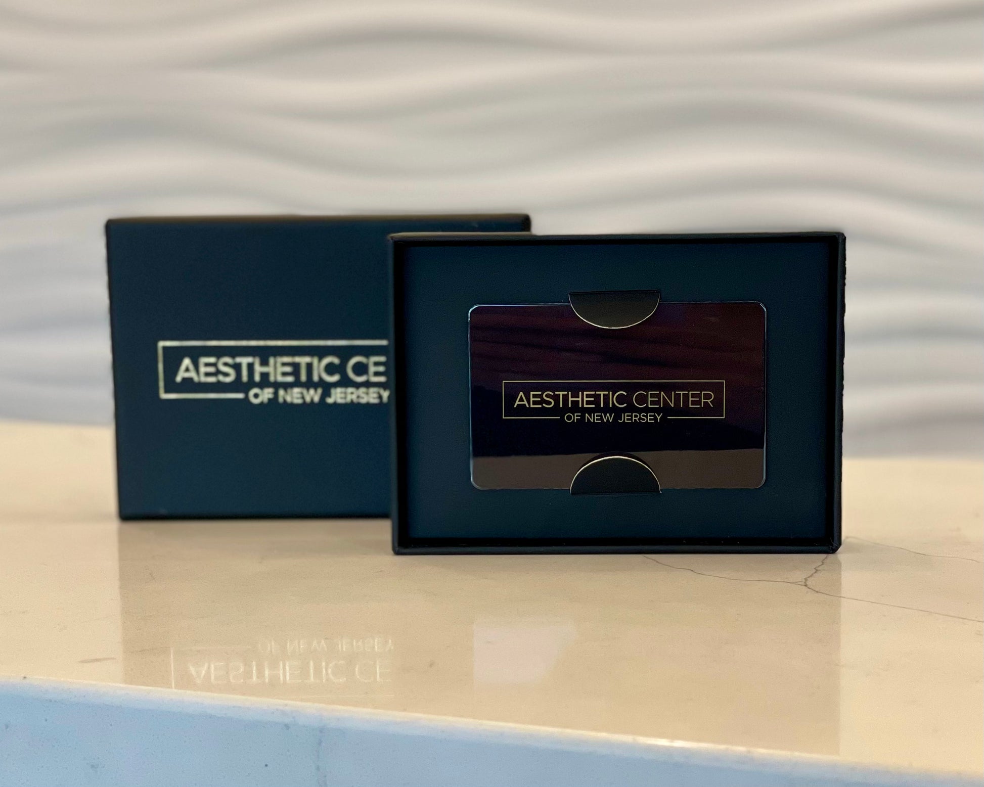 Aesthetic Center of New Jersey gift card in an open gift box.